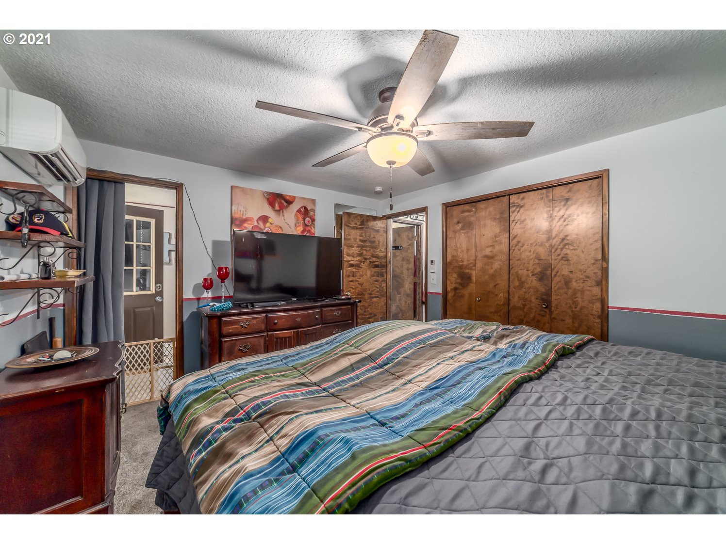 471 67th Street Springfield, OR 97478 - Photo 16 of 28 a bedroom with a bed and a flat screen tv