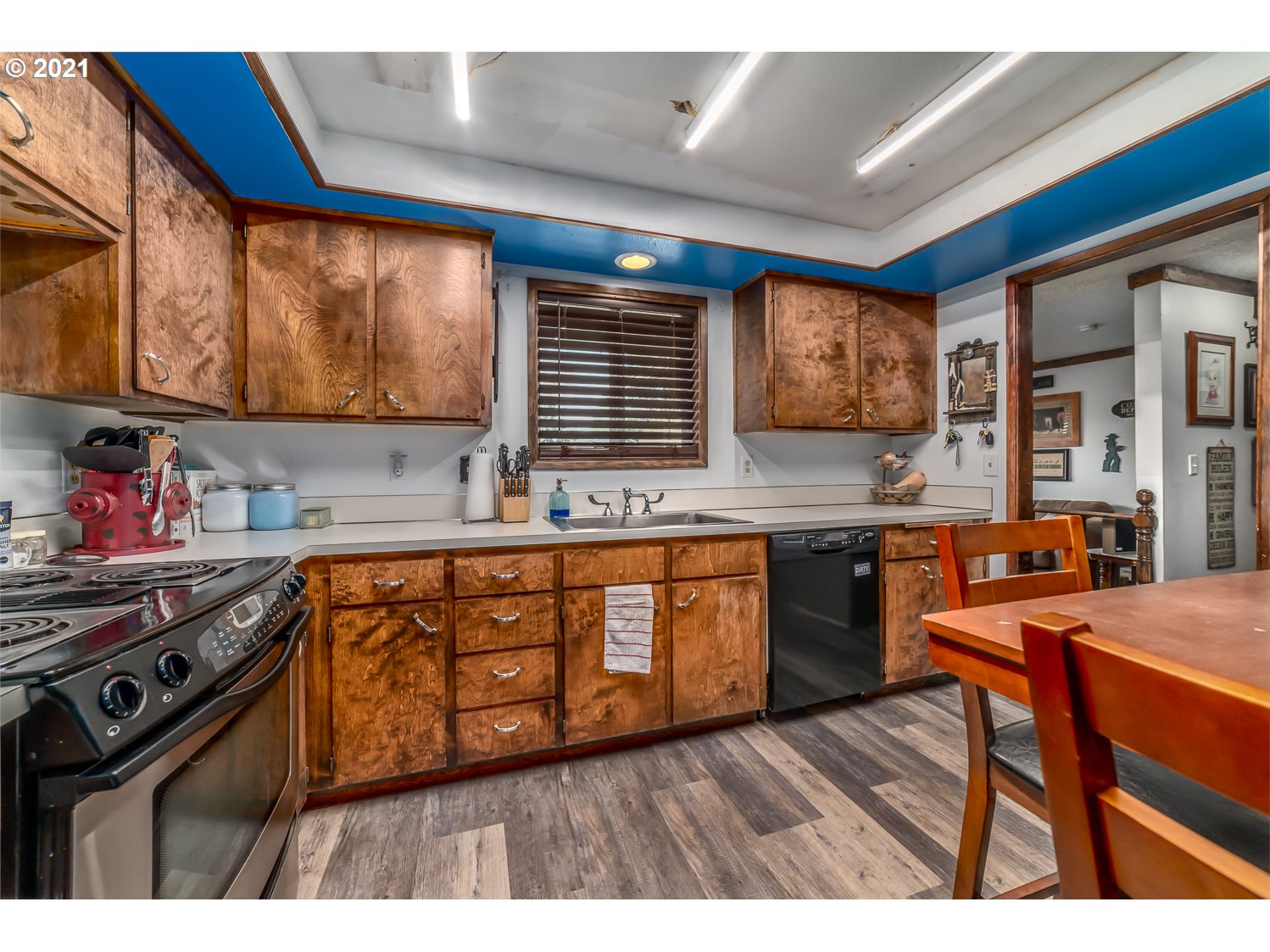 471 67th Street Springfield, OR 97478 - Photo 9 of 28 a kitchen with stainless steel appliances wooden cabinets a stove a sink and a refrigerator