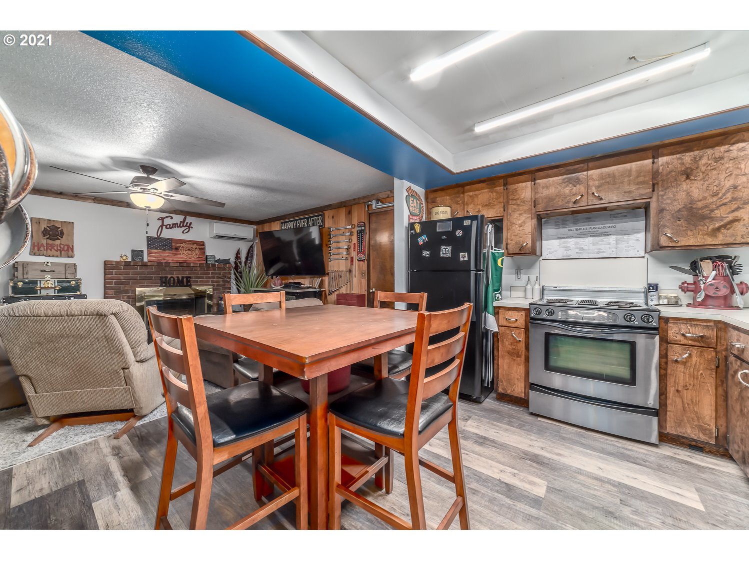 471 67th Street Springfield, OR 97478 - Photo 10 of 28 a dining hall with stainless steel appliances kitchen island granite countertop a table chairs and a refrigerator