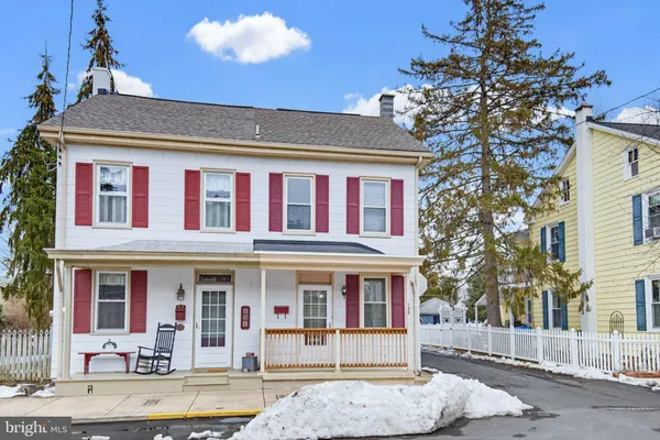 a front view of a residential apartment building with a yard