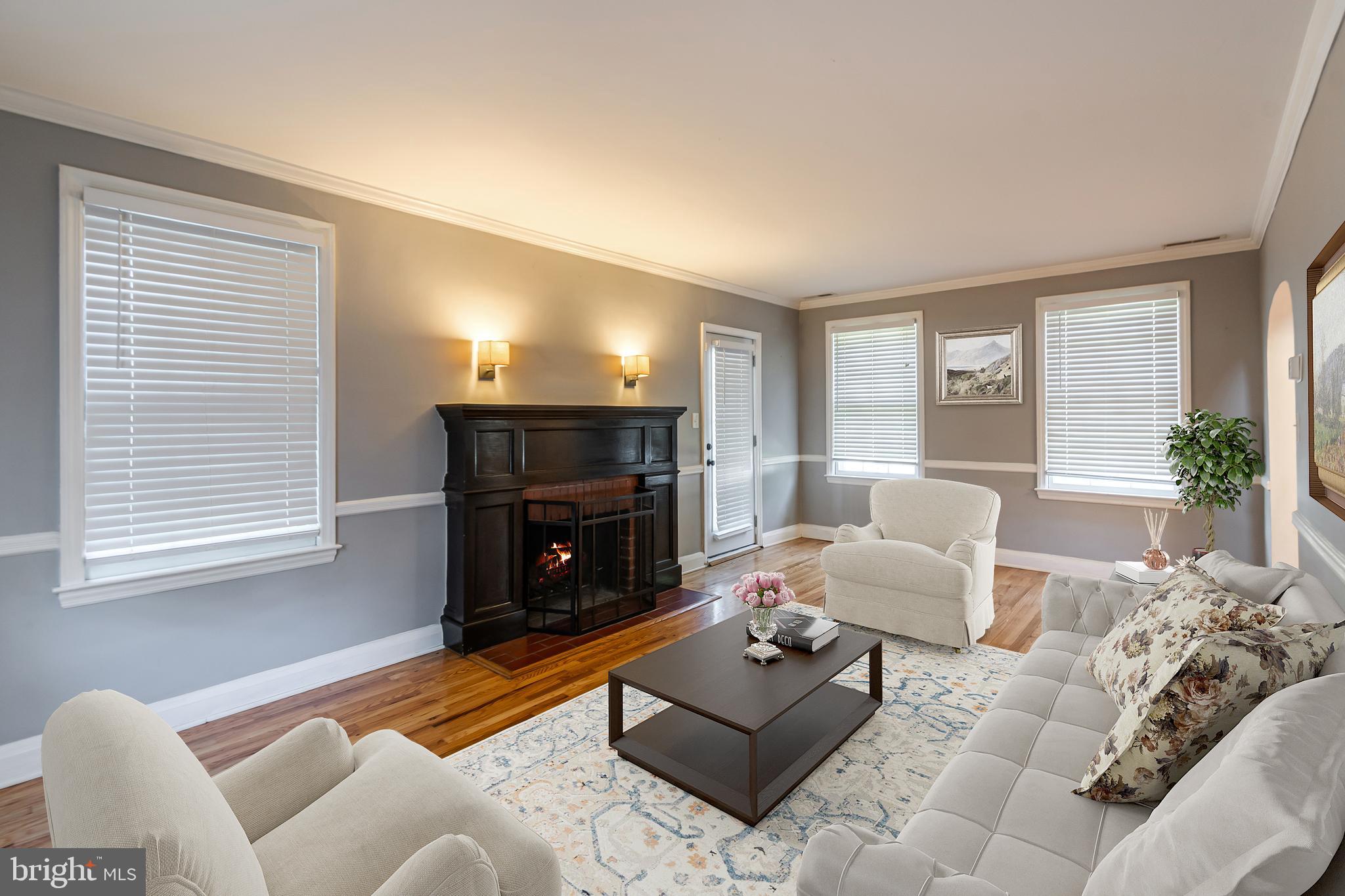 113 Homewood Road Linthicum Heights, MD 21090 - Photo 12 of 34 a living room with furniture a fireplace and a table