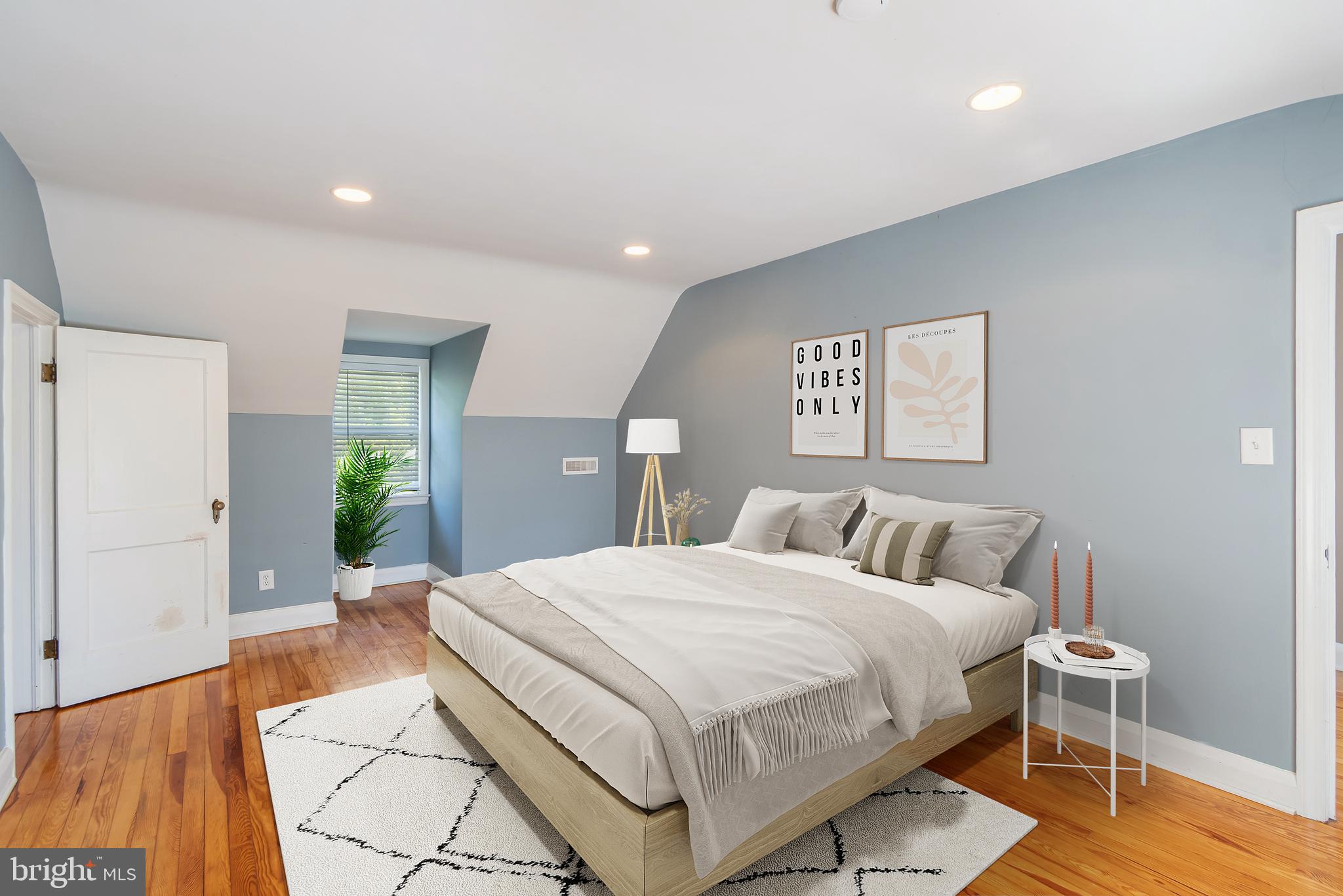 113 Homewood Road Linthicum Heights, MD 21090 - Photo 14 of 34 a bedroom with a large bed and a wooden floor