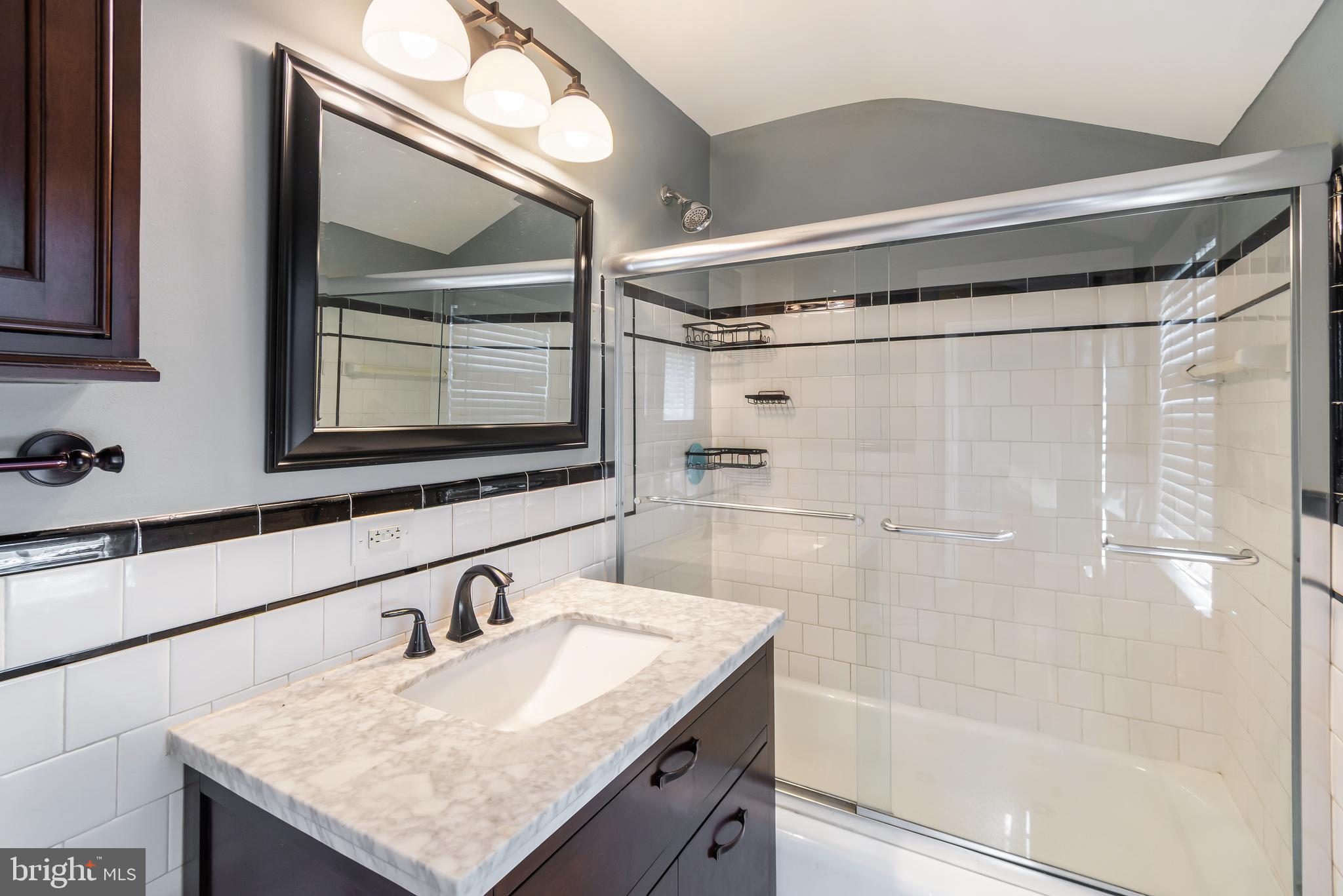 113 Homewood Road Linthicum Heights, MD 21090 - Photo 20 of 34 a bathroom with a granite countertop sink a mirror and shower
