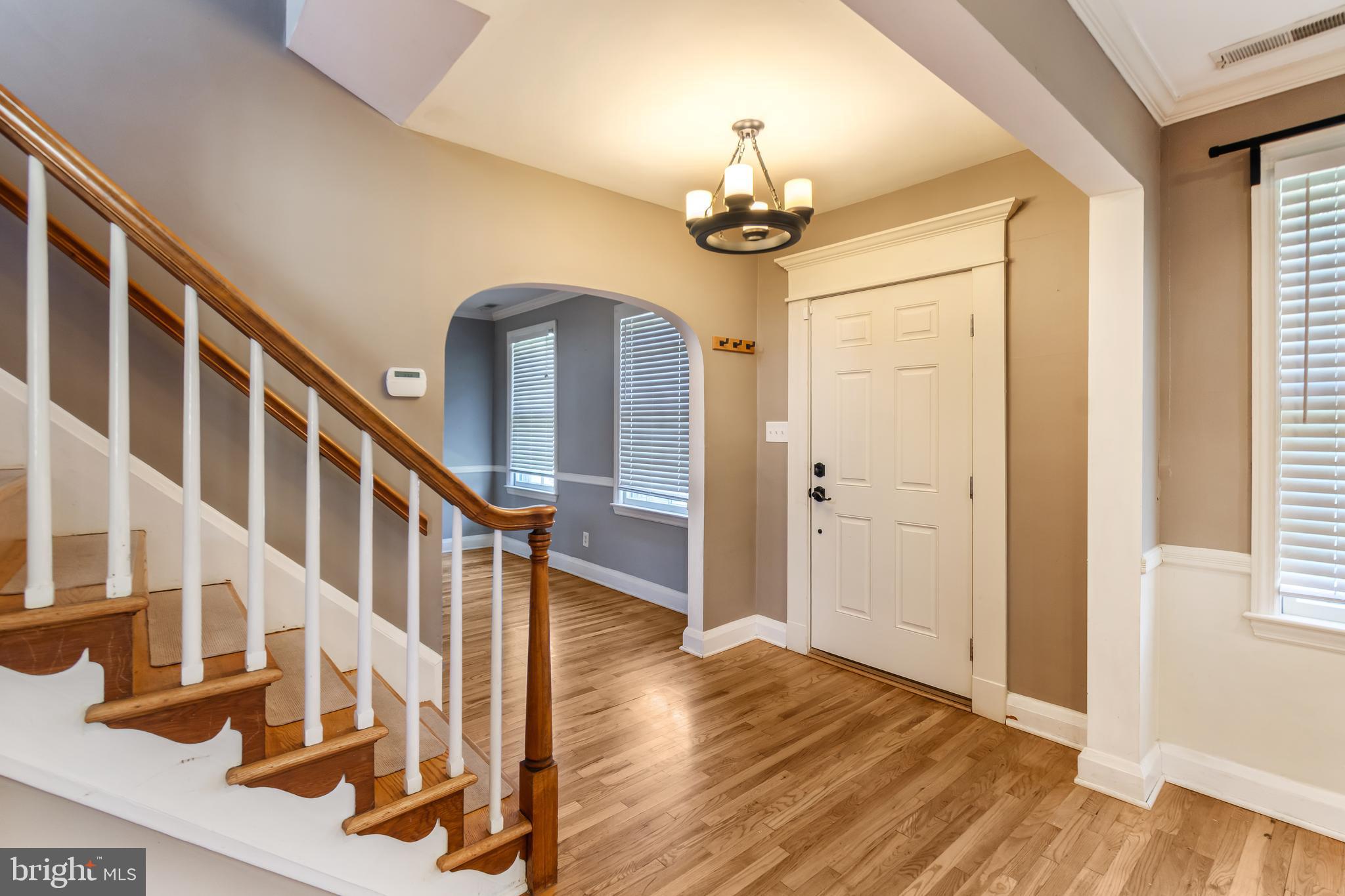 113 Homewood Road Linthicum Heights, MD 21090 - Photo 4 of 34 a view of a hallway with wooden floor and staircase