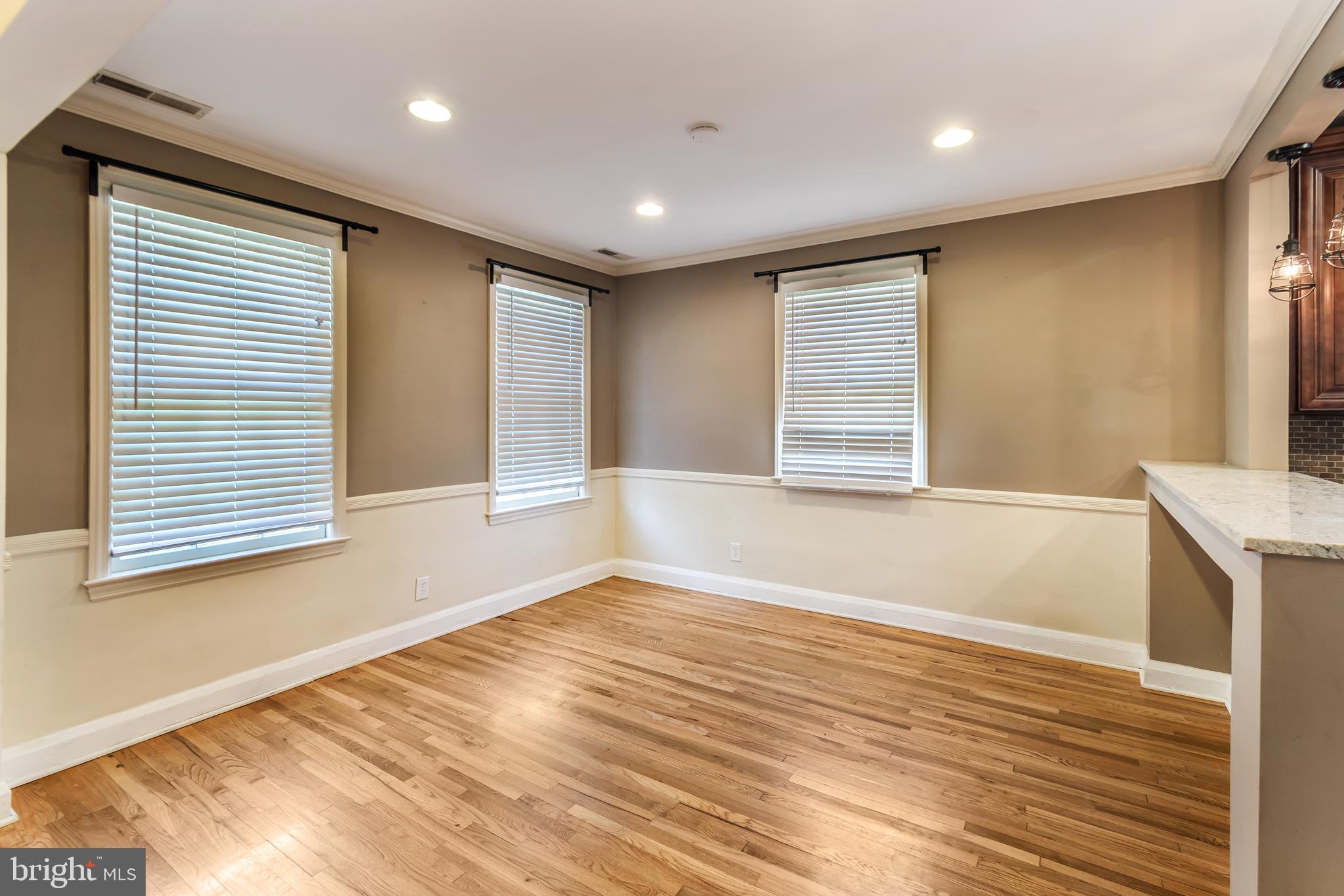113 Homewood Road Linthicum Heights, MD 21090 - Photo 6 of 34 a view of an empty room with wooden floor and a window