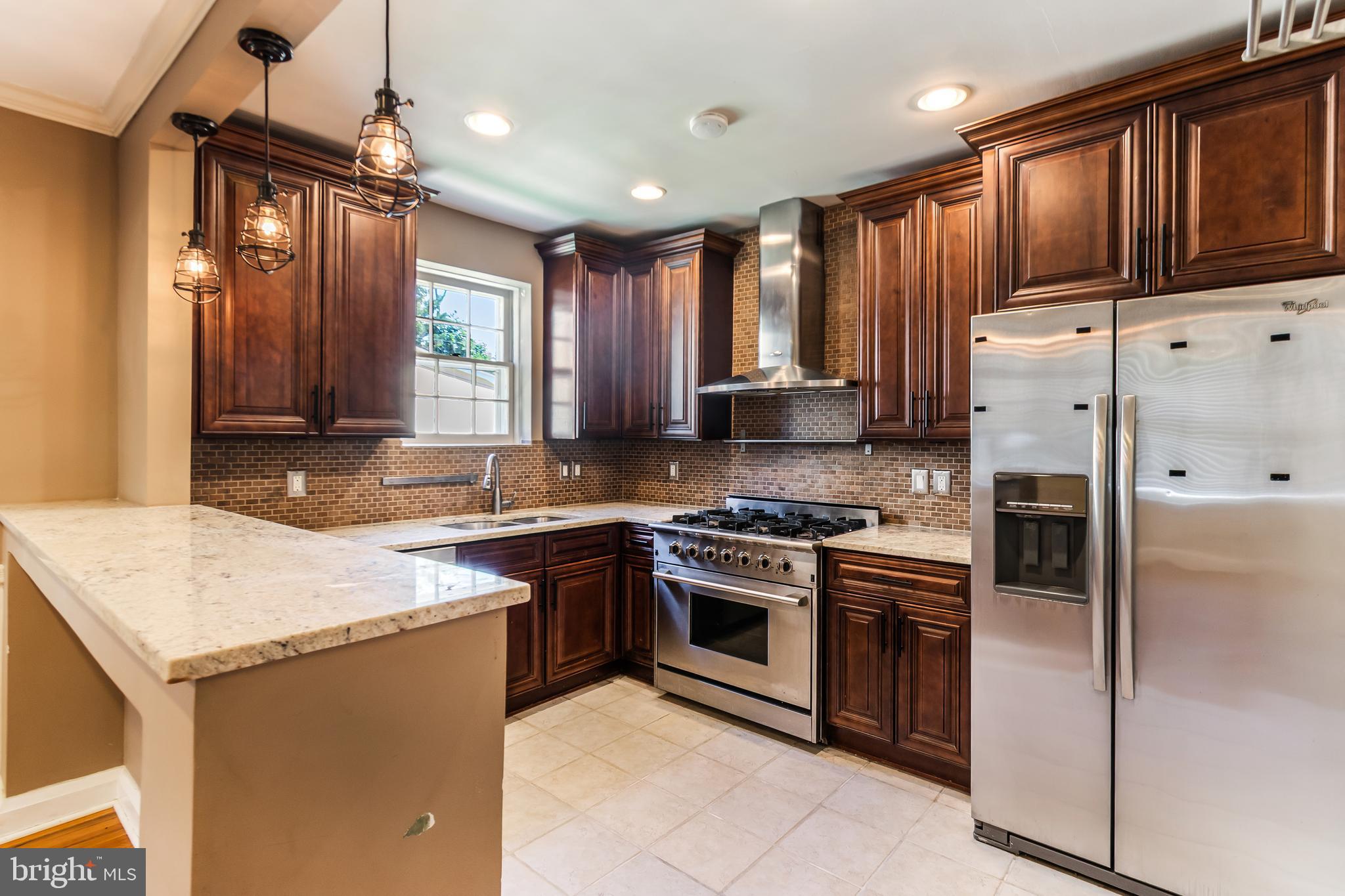 113 Homewood Road Linthicum Heights, MD 21090 - Photo 8 of 34 a kitchen with stainless steel appliances granite countertop a stove top oven a sink and a refrigerator