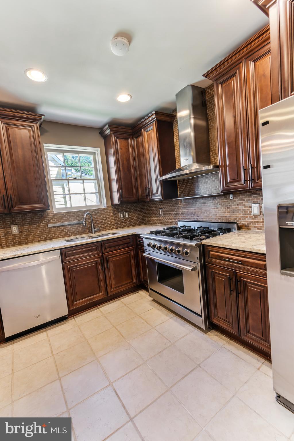 113 Homewood Road Linthicum Heights, MD 21090 - Photo 9 of 34 a kitchen with stainless steel appliances granite countertop a stove a sink and a microwave