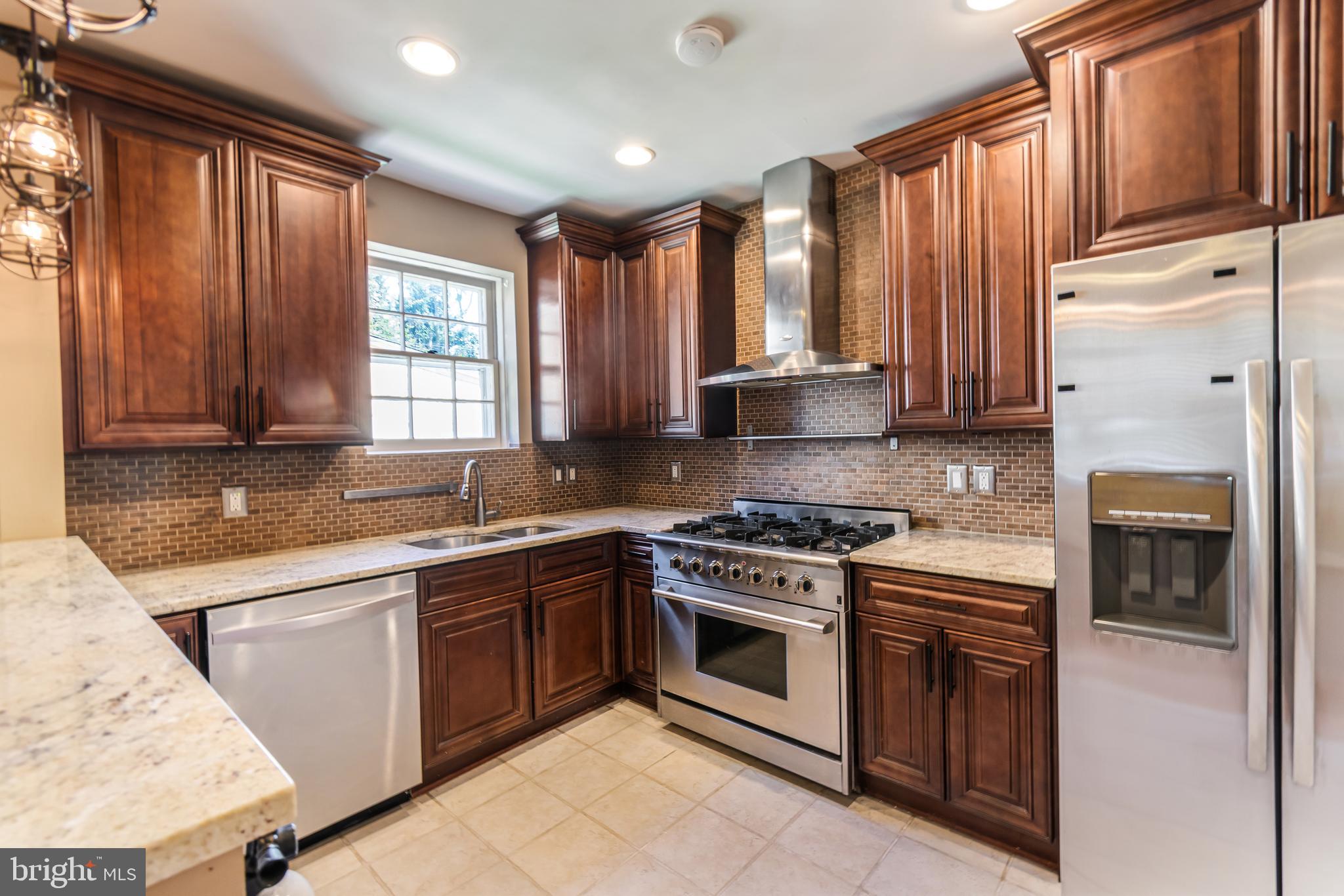 113 Homewood Road Linthicum Heights, MD 21090 - Photo 10 of 34 a kitchen with stainless steel appliances granite countertop a stove a sink and a refrigerator