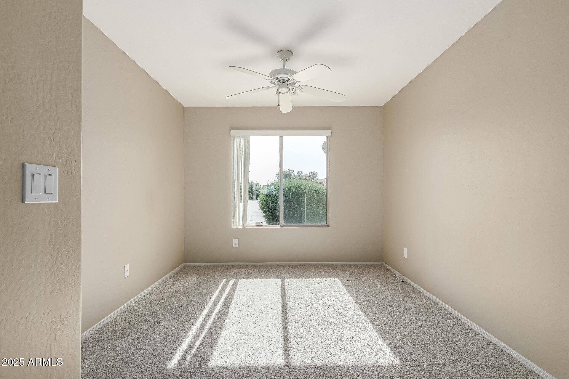 315 South 112th Drive Avondale, AZ 85323 - Photo 17 of 20 an empty room with a window and a ceiling fan