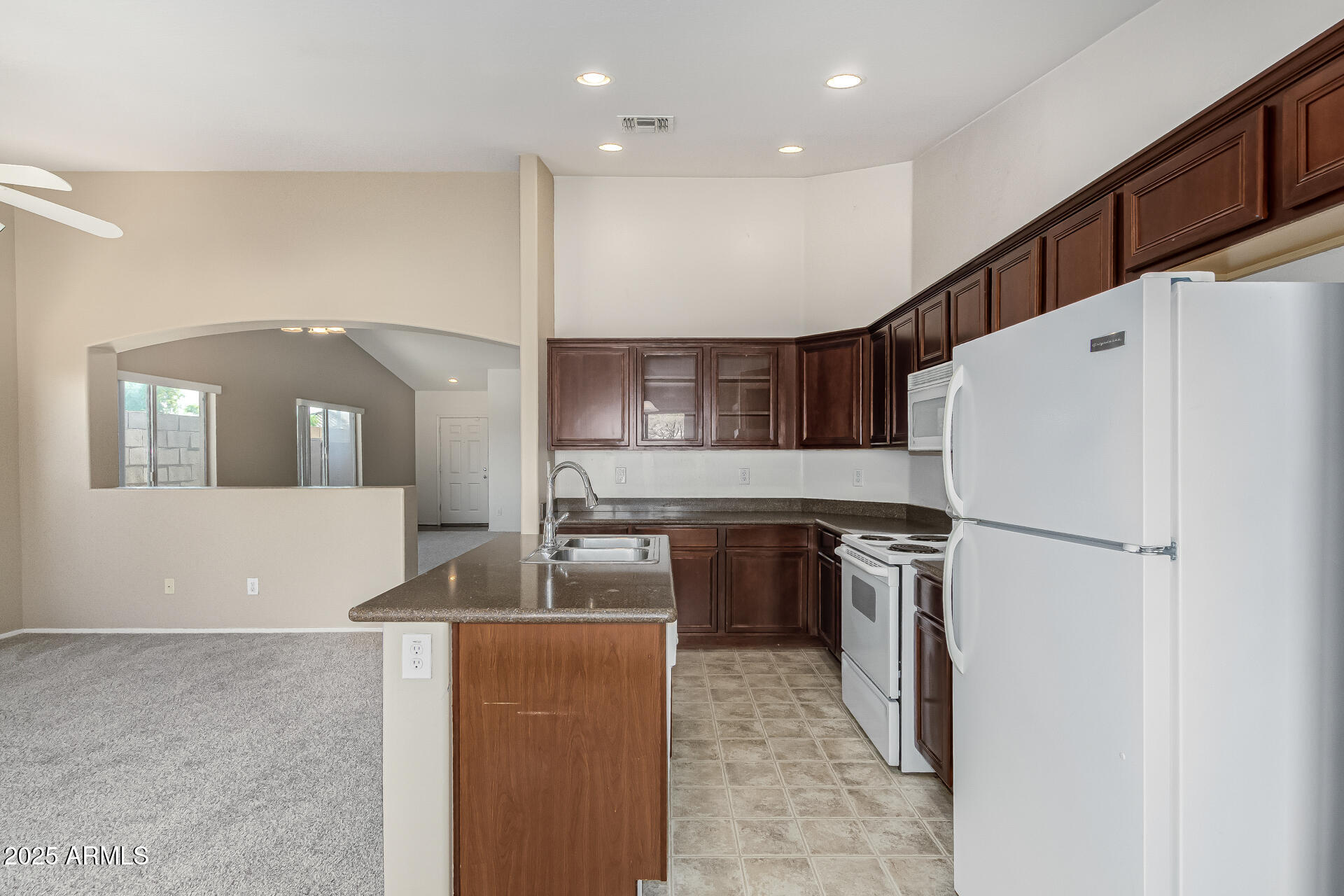 315 South 112th Drive Avondale, AZ 85323 - Photo 9 of 20 a kitchen with refrigerator a stove and a refrigerator