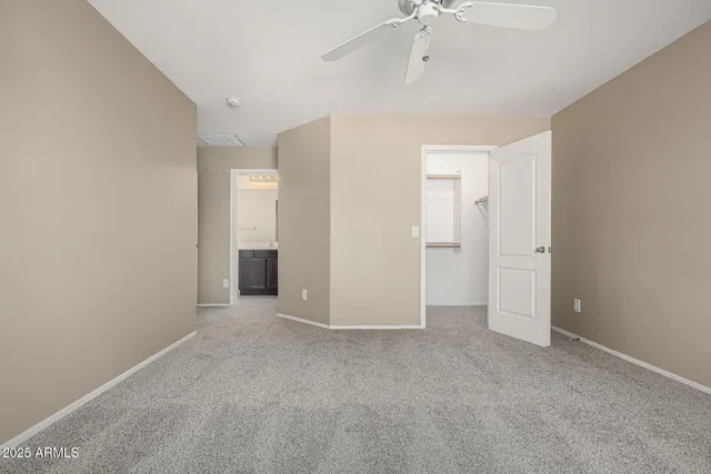a view of an empty room with a ceiling fan