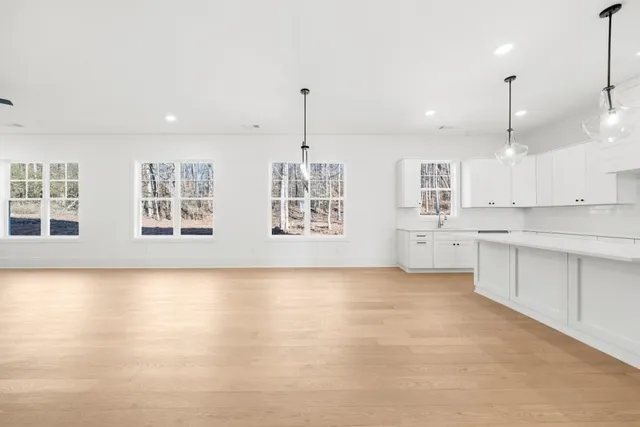a large kitchen with stainless steel appliances sink refrigerator and cabinets