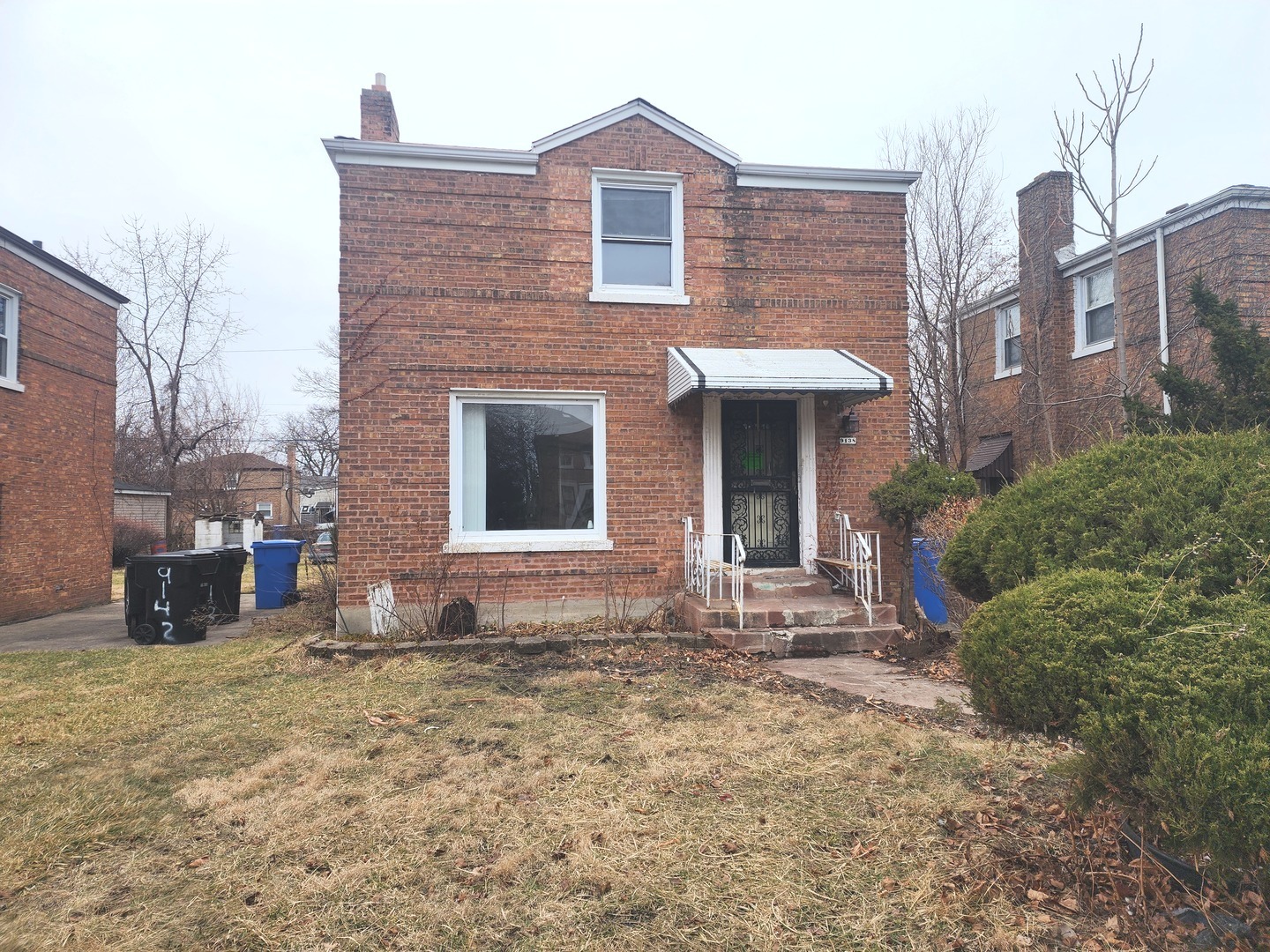 9138 South Perry Avenue Chicago, IL 60620 - Photo 2 of 2 a view of a brick house with many windows