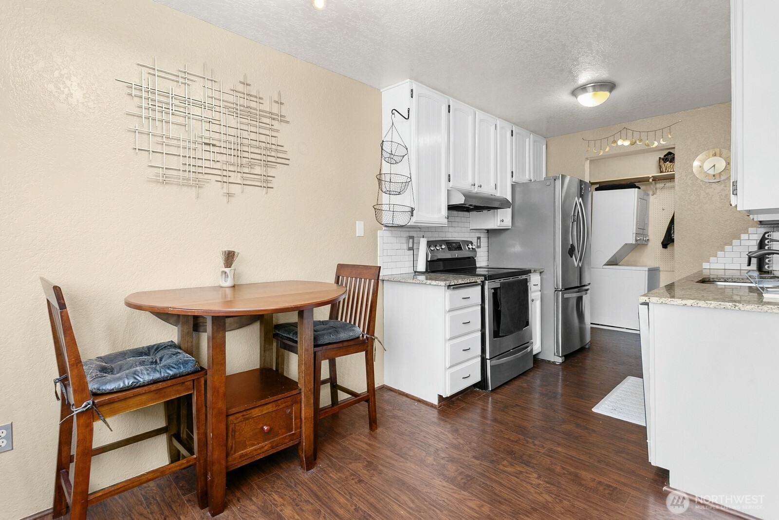 2031 Northwest 59th Street, Unit 101 Seattle, WA 98107 - Photo 12 of 22 a kitchen with appliances cabinets and wooden floor