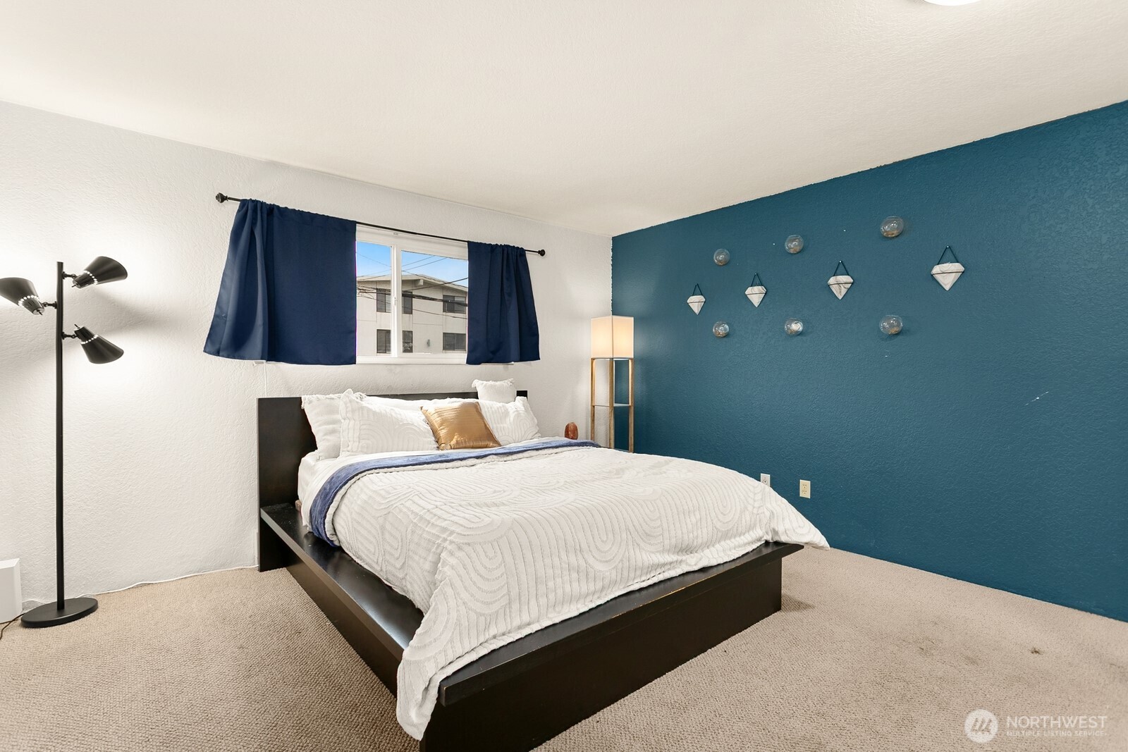 2031 Northwest 59th Street, Unit 101 Seattle, WA 98107 - Photo 16 of 22 a bedroom with a bed and a night stand