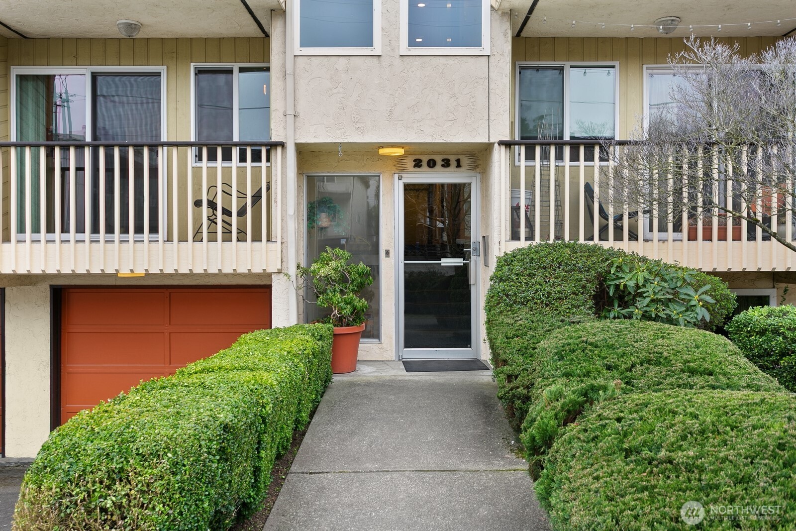 2031 Northwest 59th Street, Unit 101 Seattle, WA 98107 - Photo 3 of 22 a view of a house with a small yard and plants