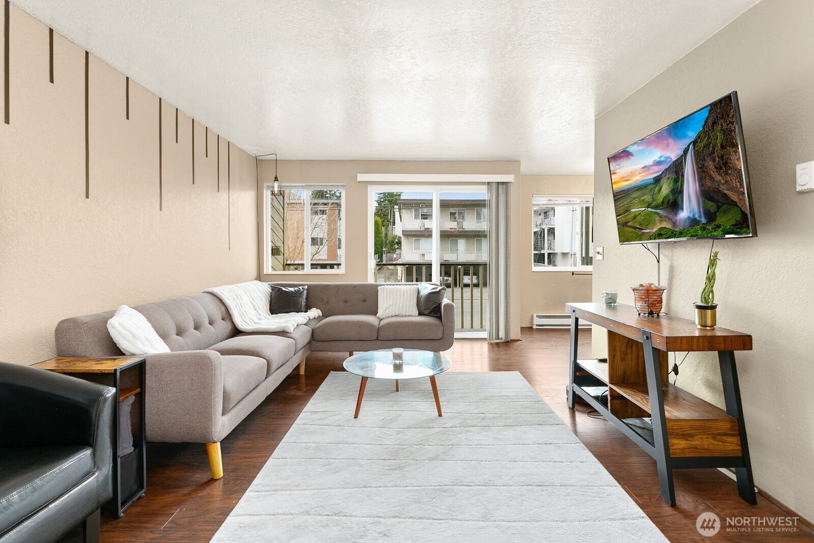 2031 Northwest 59th Street, Unit 101 Seattle, WA 98107 - Photo 6 of 22 a living room with furniture and a flat screen tv