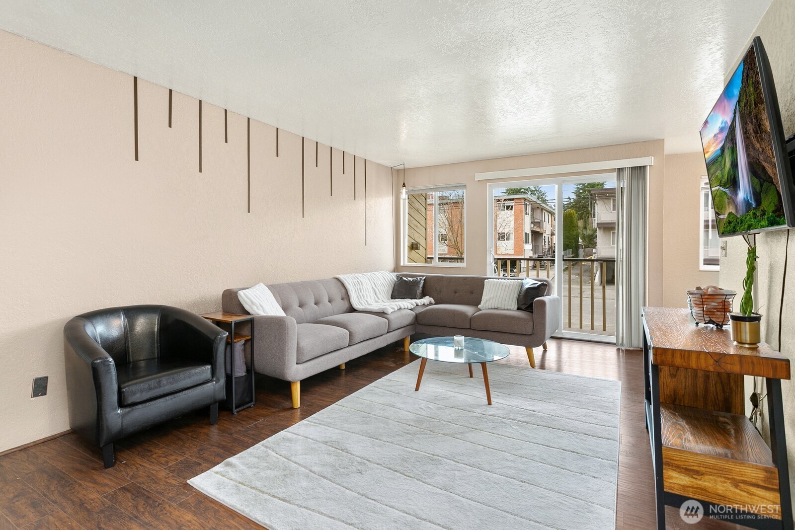 2031 Northwest 59th Street, Unit 101 Seattle, WA 98107 - Photo 7 of 22 a living room with furniture and a wooden floor