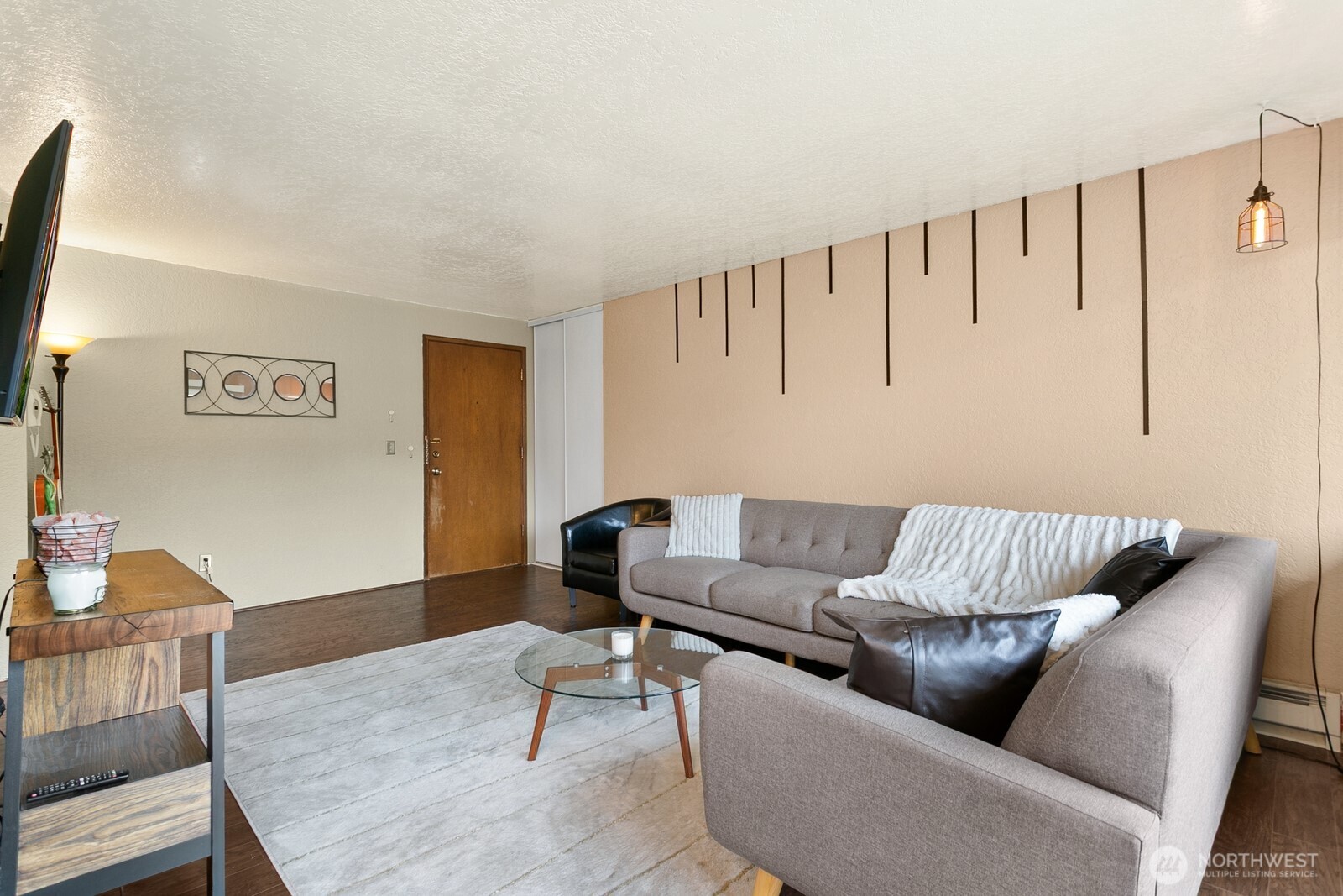 2031 Northwest 59th Street, Unit 101 Seattle, WA 98107 - Photo 8 of 22 a living room with furniture and a wooden floor