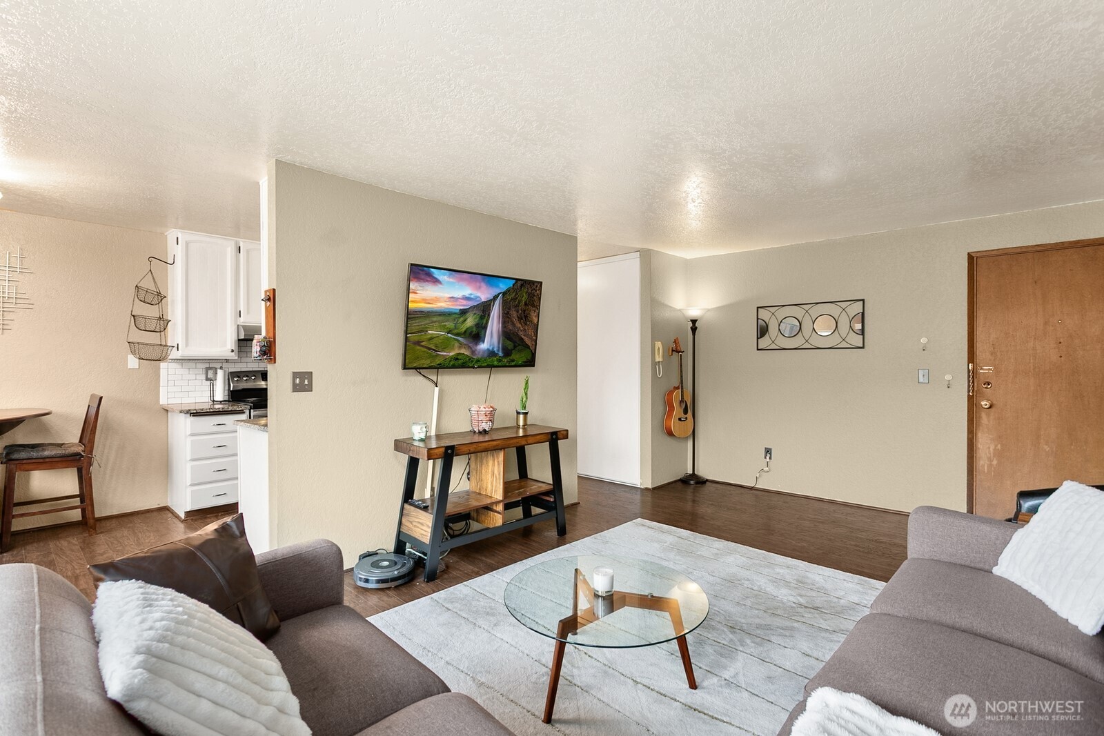 2031 Northwest 59th Street, Unit 101 Seattle, WA 98107 - Photo 9 of 22 a living room with furniture and a flat screen tv