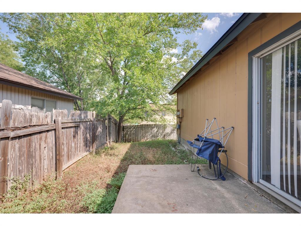 11919 Sunhillow Bend, Unit B Austin, TX 78758 - Photo 12 of 12 a backyard of a house with table and chairs