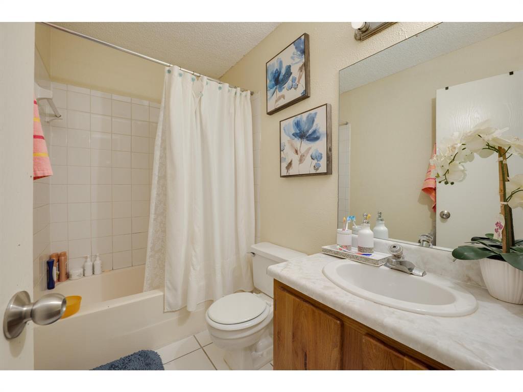 11919 Sunhillow Bend, Unit B Austin, TX 78758 - Photo 10 of 12 a bathroom with a sink a toilet and a mirror