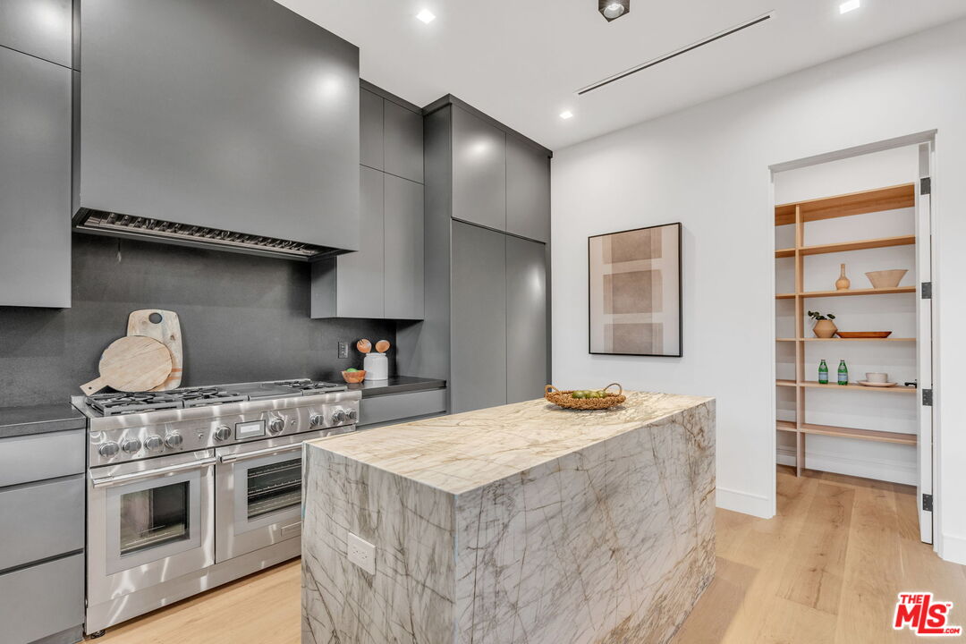 1071 Marco Place Venice, CA 90291 - Photo 11 of 39 a kitchen with stainless steel appliances granite countertop a stove and a refrigerator
