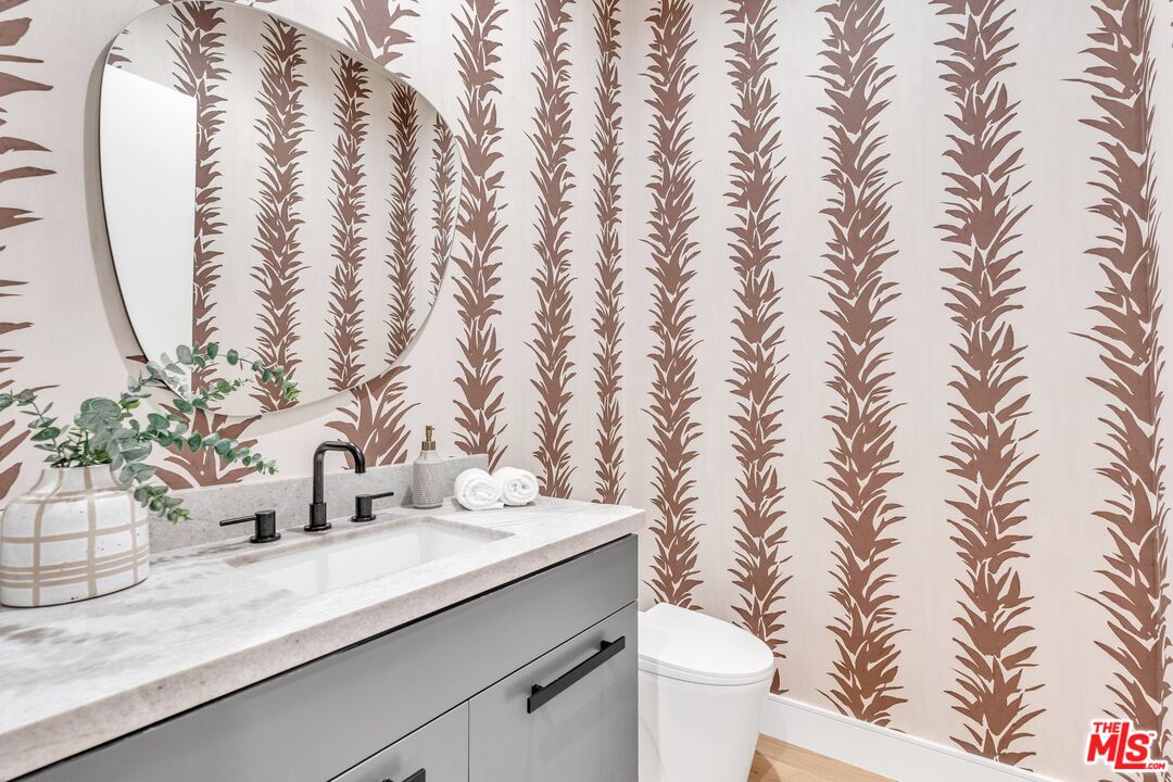 1071 Marco Place Venice, CA 90291 - Photo 14 of 39 a bathroom with a granite countertop sink and a toilet