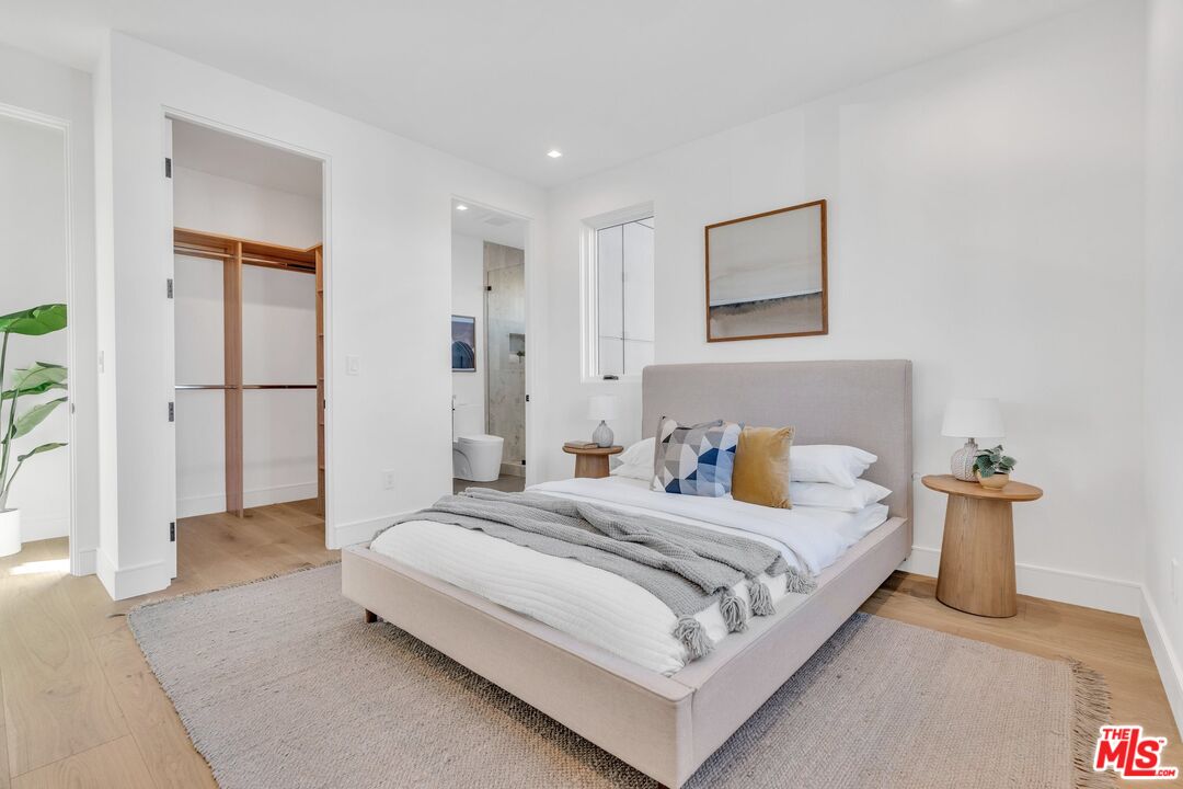 1071 Marco Place Venice, CA 90291 - Photo 15 of 39 a bedroom with a bed and a lamp