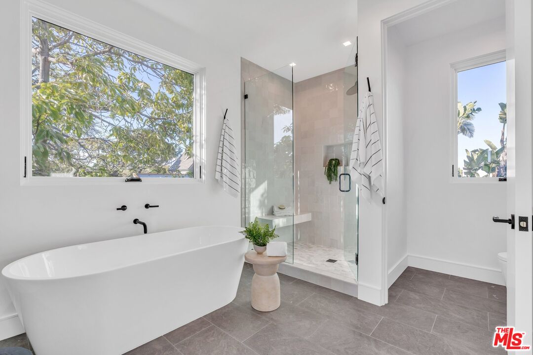 1071 Marco Place Venice, CA 90291 - Photo 24 of 39 a white bath tub sitting next to a white toilet and a shower