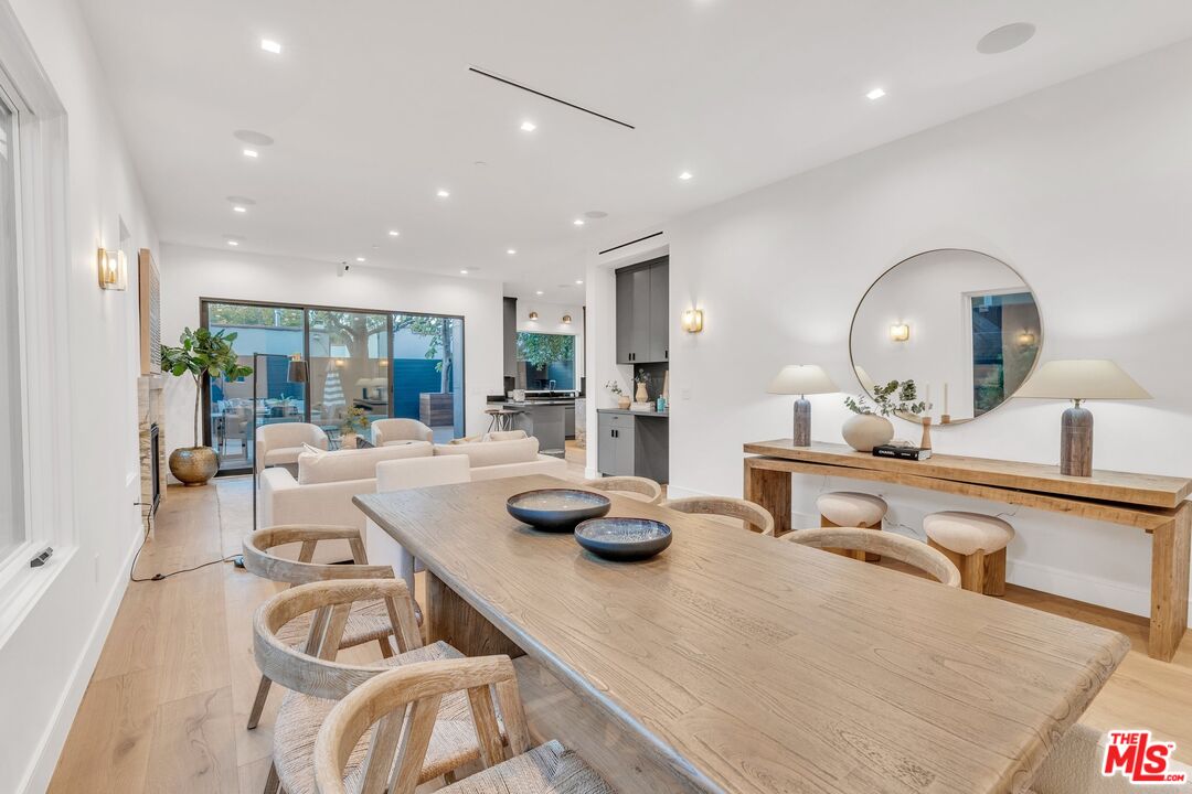 1071 Marco Place Venice, CA 90291 - Photo 5 of 39 a kitchen with stainless steel appliances granite countertop a white table chairs and a wooden floor