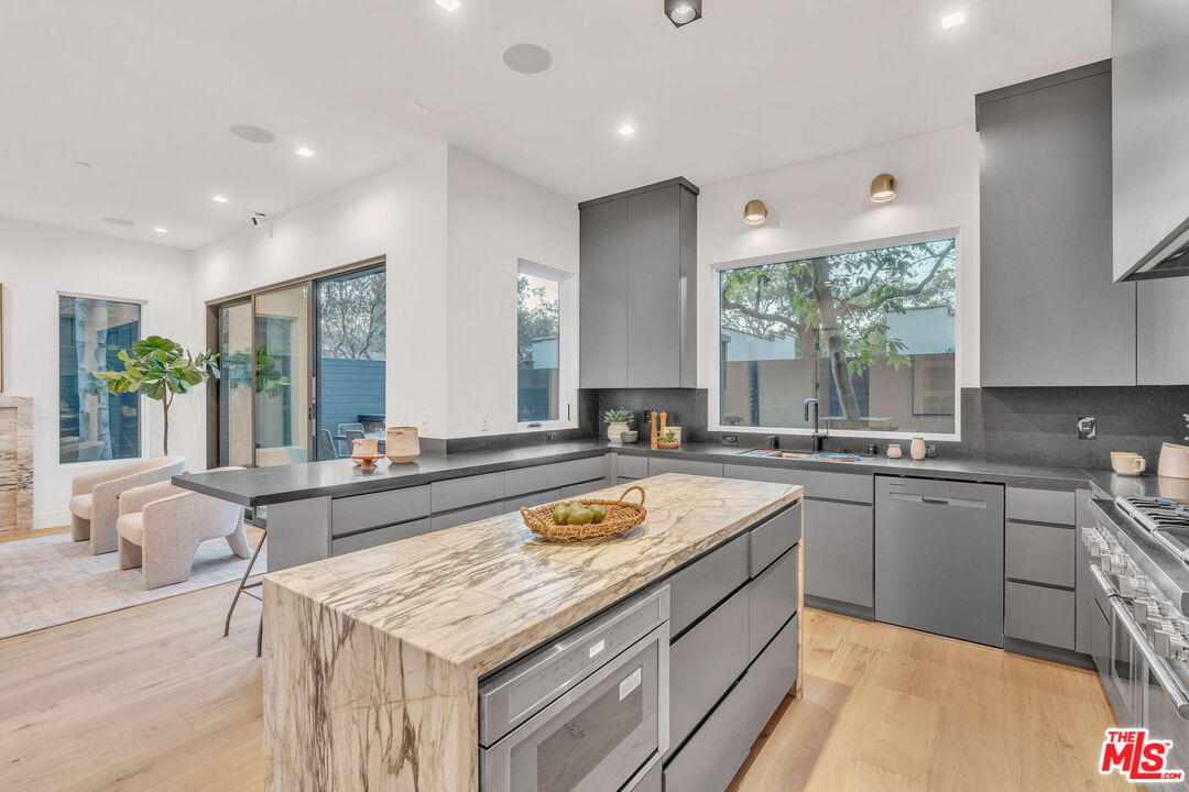 1071 Marco Place Venice, CA 90291 - Photo 10 of 39 a large kitchen with a stove a sink dishwasher and cabinets with wooden floor