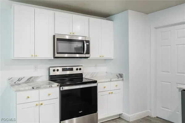 a kitchen with appliances a sink and cabinets