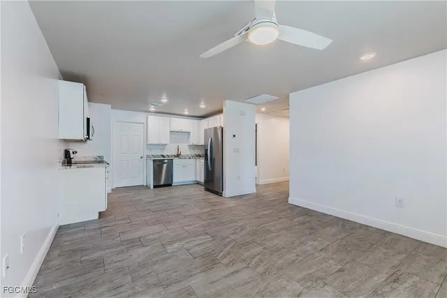 a view of a kitchen with a sink and a refrigerator