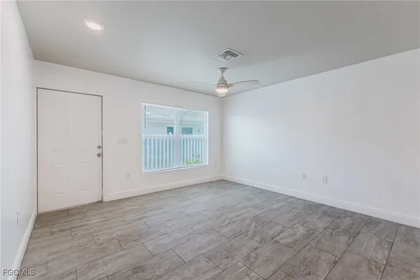 wooden floor in an empty room with a window
