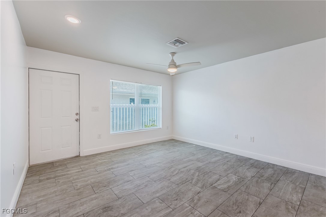 2405 Maple Avenue Fort Myers, FL 33901 - Photo 23 of 27 wooden floor in an empty room with a window
