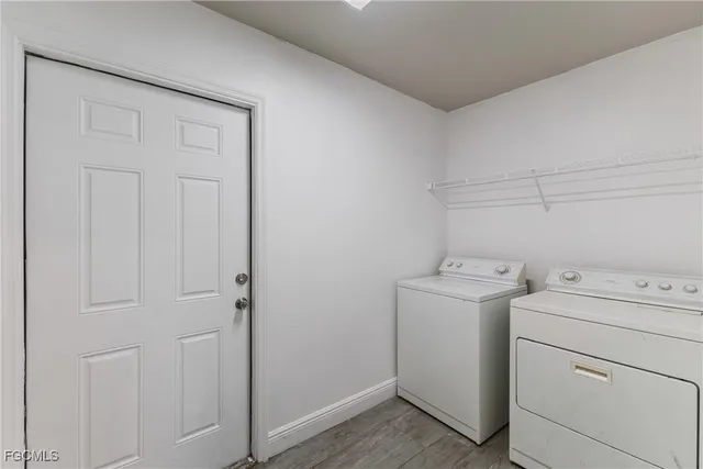 a view of storage and utility room with washer and dryer