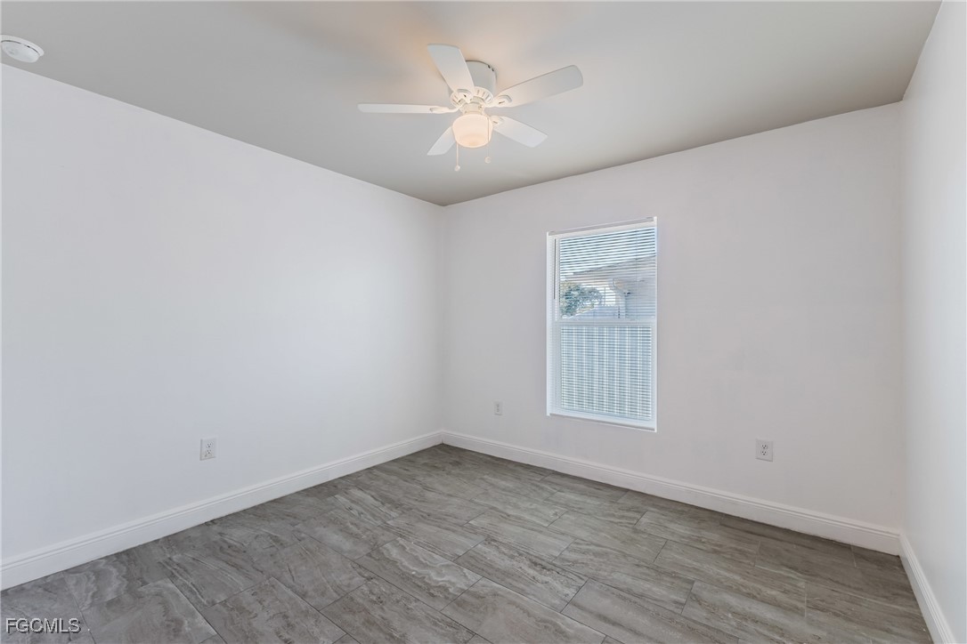 2405 Maple Avenue Fort Myers, FL 33901 - Photo 6 of 27 an empty room with wooden floor and windows