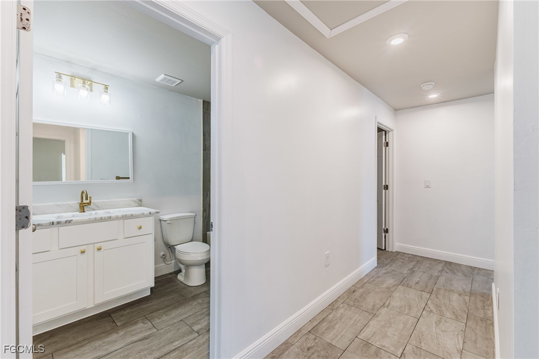 2405 Maple Avenue Fort Myers, FL 33901 - Photo 7 of 27 a bathroom with a double vanity sink and a mirror