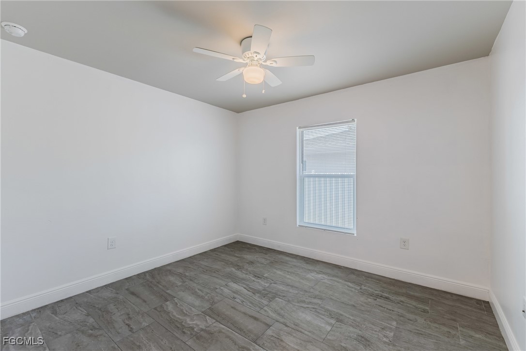 2405 Maple Avenue Fort Myers, FL 33901 - Photo 10 of 27 an empty room with wooden floor and fan