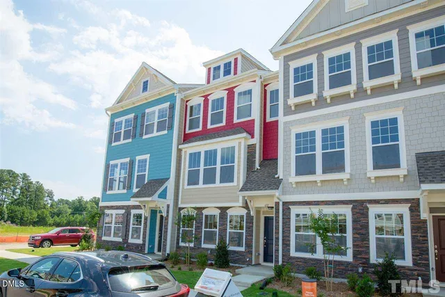 a front view of building with cars parked