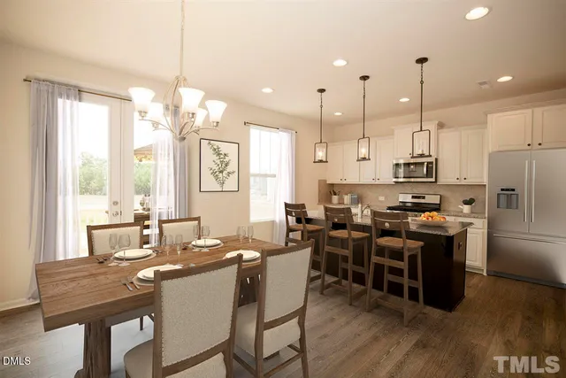 a large kitchen with a table and chairs