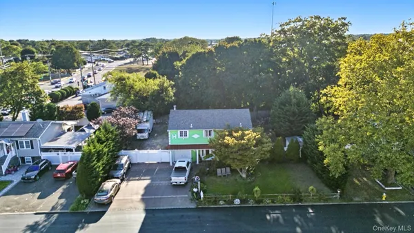 an aerial view of residential houses with outdoor space and street view