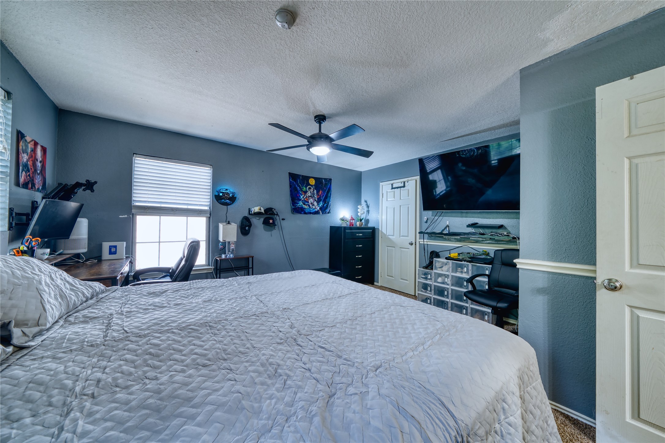 2210 Mountain Ranch Drive Houston, TX 77049 - Photo 27 of 36 a large bedroom with a bed and a flat screen tv