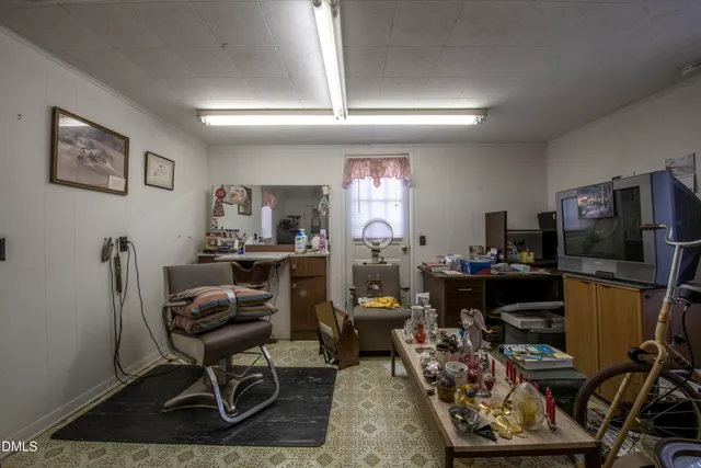 a living room with furniture a flat screen tv and a table