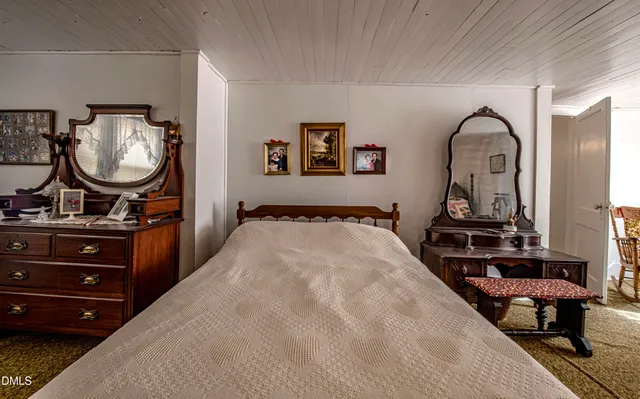 a bedroom with a bed and a dresser