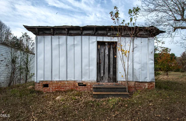a view of a house with a wooden fence