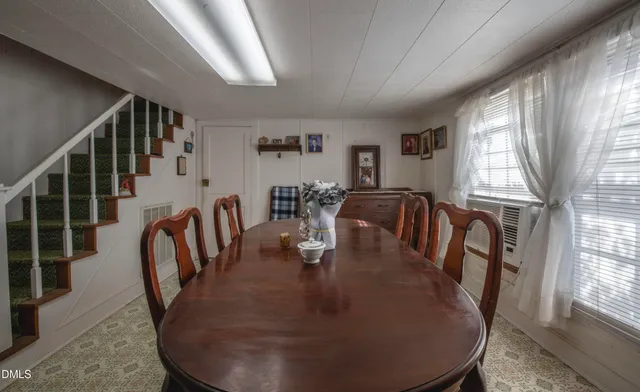 a dining room with furniture a rug and wooden floor