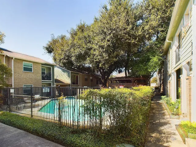 a view of a house with a small yard and plants