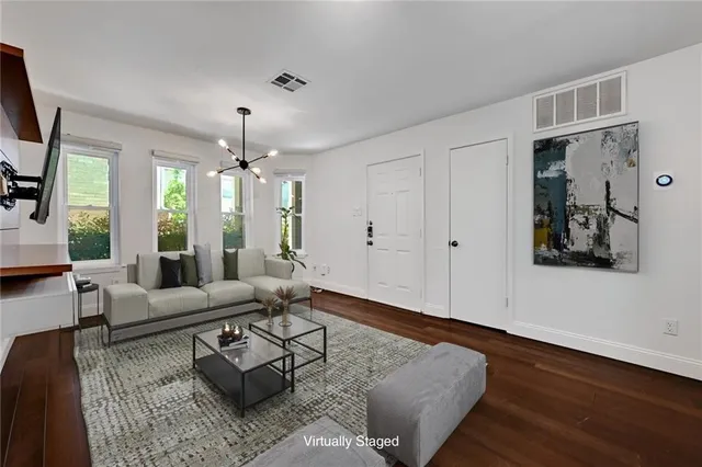 a living room with furniture and wooden floor